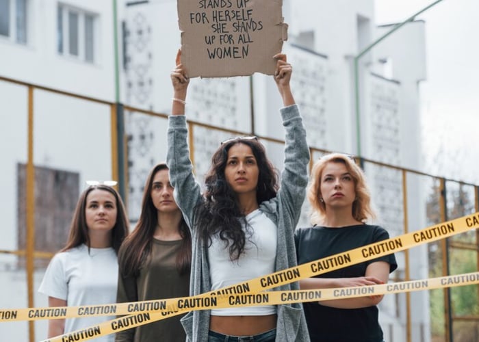 Women protesting with a sign for safety rights