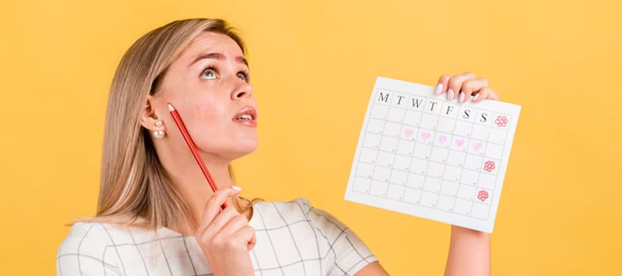 A pretty girl holding a calendar to pencil in an escort booking